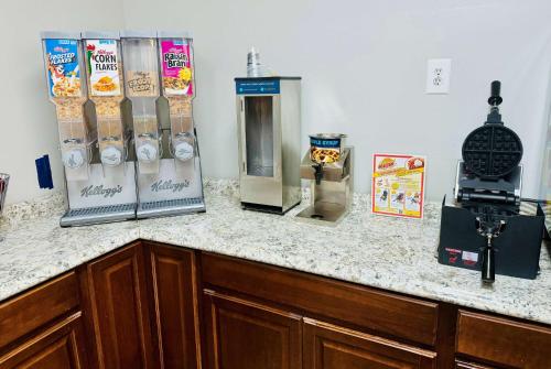 a kitchen with a counter with some food items on it at Ramada by Wyndham Lumberton in Lumberton