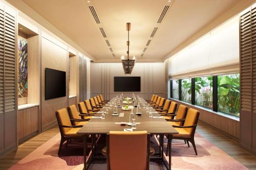 a large conference room with a long table and chairs at Hilton Kuching Hotel in Kuching