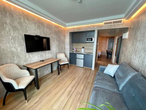 a living room with a couch and a table at C Tower Premium Apartments, Panoramic Sea View in Netanya