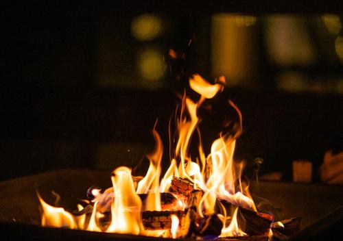 a fire is burning in a fire pit at Gran Classe in Matsuida