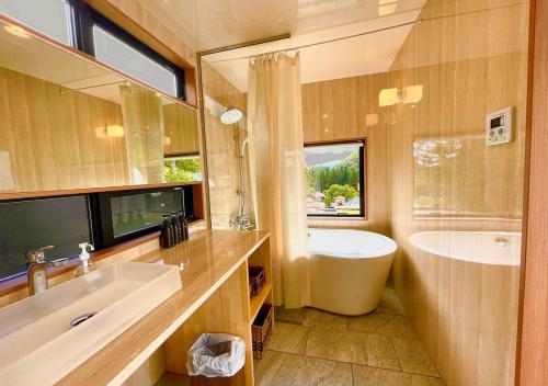 a bathroom with a tub and a sink and a bath tub at Gran Classe in Matsuida