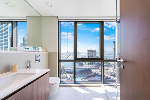 a bathroom with a view of a city at FAM Living - Vida Residences Stylish 2BR Creekfront Charm in Dubai