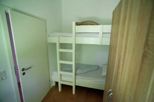 a white bunk bed in a small room at Ferienhaus Robinson Crusoe Schwarzkittelpfad 80 in Waldbrunn