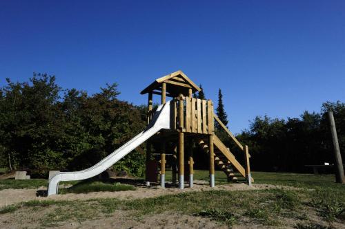 a playground with a slide in a park at Ferienhaus Winnetou Im Abendrot 127 in Waldbrunn