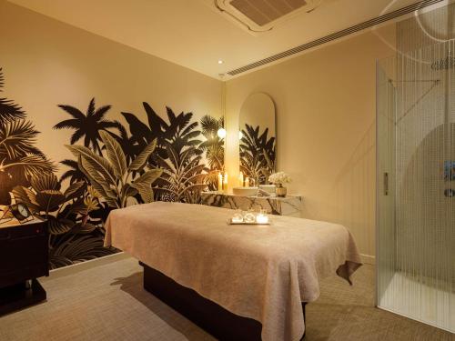 a bedroom with a bed with a plant wall at Rixos Premium Dubrovnik in Dubrovnik