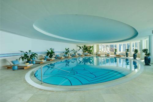 a large swimming pool in a hotel lobby at Rixos Premium Dubrovnik in Dubrovnik