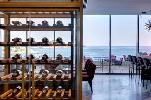 a wine tasting room with a view of the ocean at Rixos Premium Dubrovnik in Dubrovnik