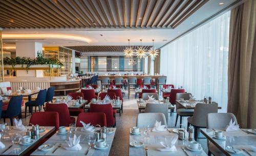 a restaurant with tables and chairs and a bar at Rixos Premium Dubrovnik in Dubrovnik