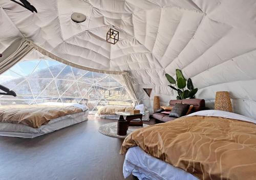 a bedroom with two beds and a large window at Gran Classe in Matsuida