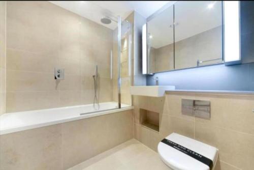 a bathroom with a toilet and a shower and a sink at Unique 3BR 3BATH Townhouse Duplex SmartHome in London
