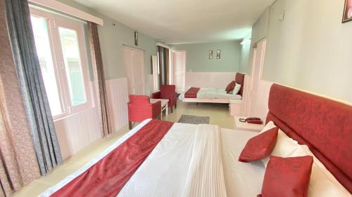 a bedroom with a bed and a living room at Hotel Meadows view in Manāli