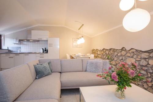 a living room with a couch and a kitchen at Apartments Lina in Vrh