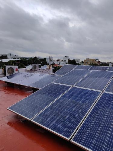 a group of solar panels on top of a roof at The Beach House in Chennai