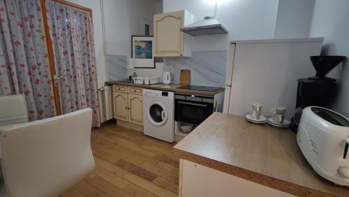 a small kitchen with a washer and dryer in it at Chambre Luxurieux Gris in Perpignan
