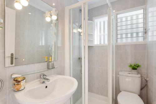 a bathroom with a toilet and a sink and a shower at Villa Anais - PlusHolidays in Calpe
