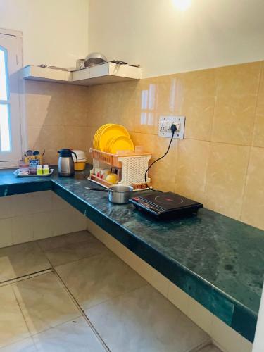 a kitchen with a counter top with a stove at Wonder homes in Chhota Simla
