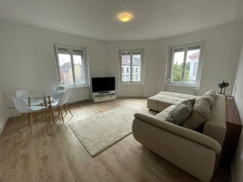 a living room with a couch and a table at Mulhouse, Urban Family Nest in Mulhouse
