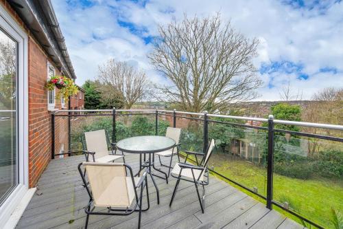 a patio with a table and chairs on a balcony at *RD98BL* For your most relaxed & Cosy stay + Free Parking + Free Fast WiFi * in Farnley