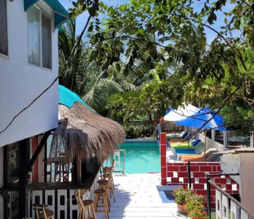 a resort with a swimming pool with chairs and umbrellas at Summer beach hotel in El Charquito