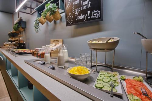 a buffet line with vegetables and other foods on it at Hotel Halbert in Groningen