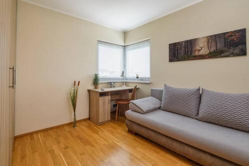 a living room with a couch and a table at ABG House Ecser 