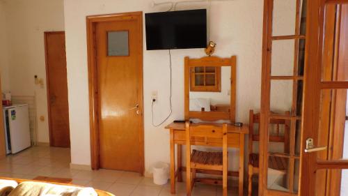 a room with a desk and a television on a wall at Thaleia view in Perdika