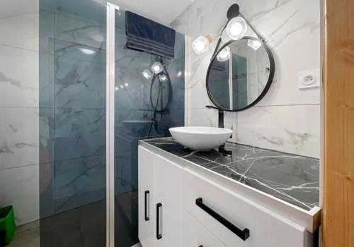 a bathroom with a sink and a mirror at AUBAGNE CASSIS MARSEILLE MAISON AVEC JARDIN et PARKING in Aubagne