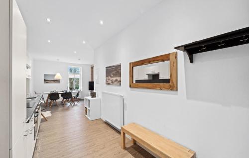 a white living room with a bench and a table at Ferienwohnung Matilda in Loxstedt