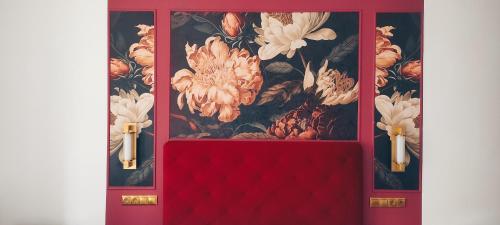 a red door with a floral wallpaper on it at L Suites The Writer's House in Gythio