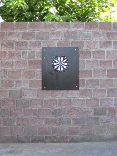 a dart board on a brick wall at De Hoog Velden 12 in Pelt