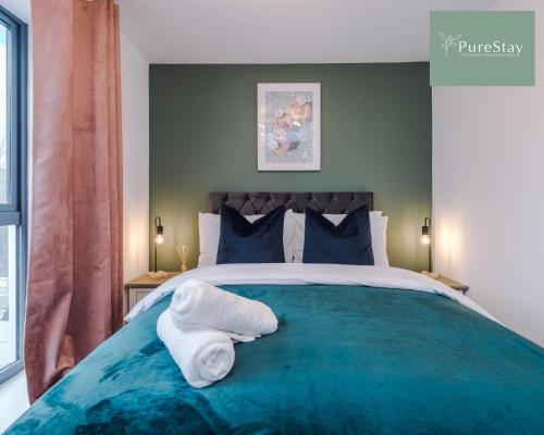 a bedroom with a bed with towels on it at Stylish Five Bedroom House By PureStay Short Lets & Serviced Accommodation Failsworth With Free Parking in Manchester
