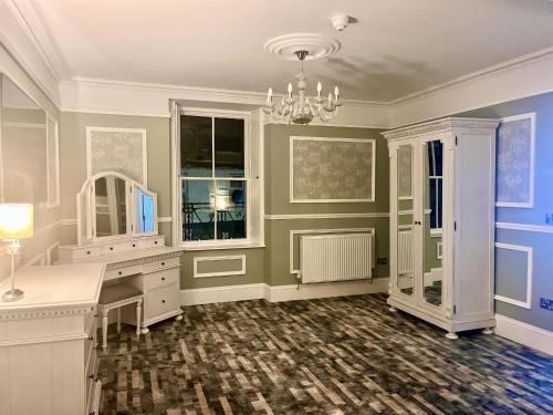 a home office with a desk and a mirror at Kings Arms Hotel in Lockerbie