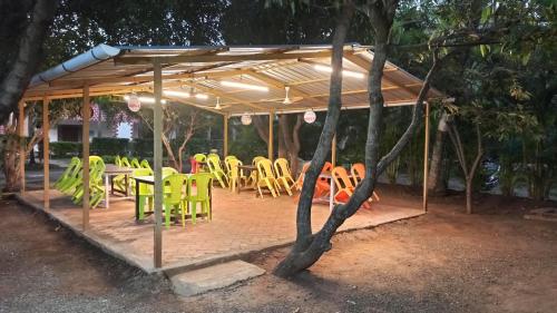 a group of tables and chairs under a pavilion at Kamal Homes in Kīhīm