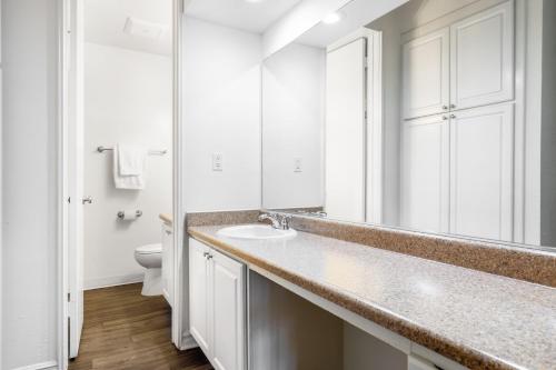 a white bathroom with a sink and a toilet at Culver City 2BR w Gym Pool nr shops LAX-328 in Los Angeles