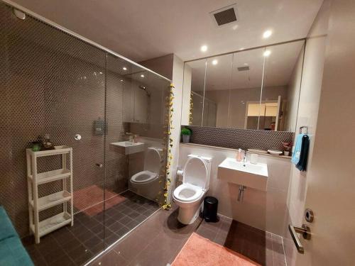 a bathroom with a toilet and a sink and a shower at Stylish 1 bedroom best location in Sydney