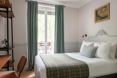a hotel room with a bed and a window at Hôtel De La Porte Dorée in Paris