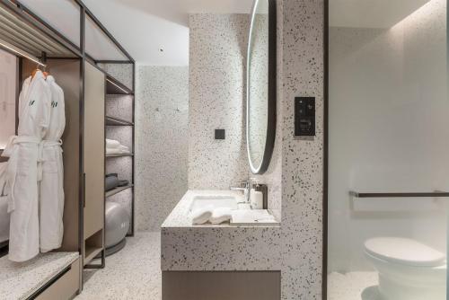 a bathroom with a sink and a toilet at EVEN Hotel Zhongshan City Center, an IHG Hotel in Zhongshan