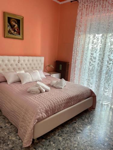 a bedroom with a bed with two towels on it at Casa Zaccardi in Vasto