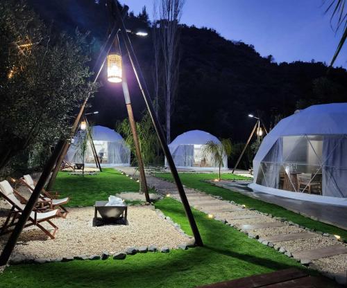 a night view of a tent and a lawn with a light at River Glamping Kalopanayiotis in Kalopanayiotis