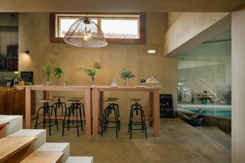 a kitchen with a bar with stools in it at Azenhas do Mar Valley House in Sintra