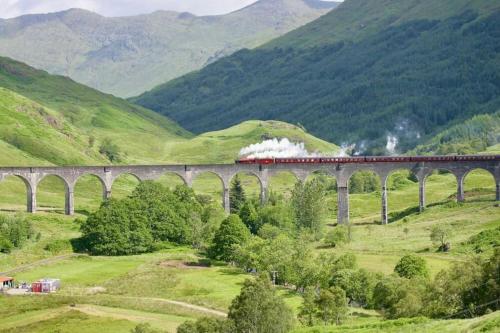 a train on a bridge in the mountains at Fort William - Highland holiday home in Fort William