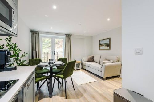 a kitchen and living room with a table and a couch at No.44 - Deluxe 2-Bedroom Duplex with Balcony in Stoney Middleton