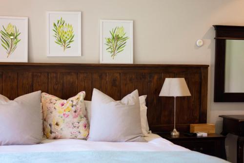 a bedroom with a bed with white sheets and pillows at African Sands B&B in Amanzimtoti