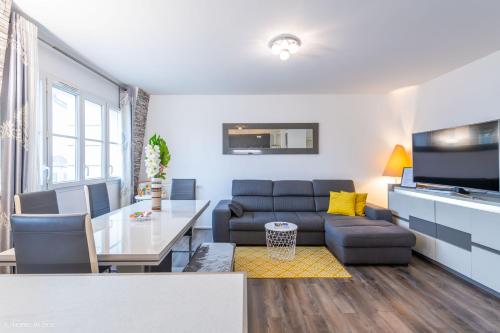 a living room with a couch and a table at *SPACIOUS APARTMENT DISNEYLAND PARIS* in Serris