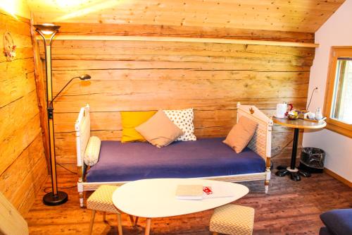 a room with a couch and a table in a room at Mys Chalet in Jaun
