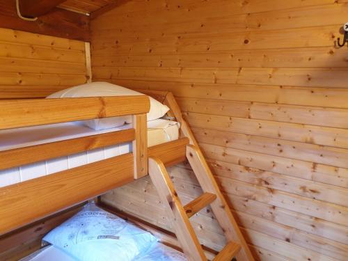 a room with two bunk beds in a log cabin at Brevar Vakantie - Porlezza in Porlezza