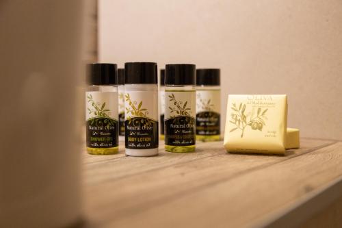 four bottles of essential oils sitting on a shelf at Hotel Katafigio in Elati Trikalon