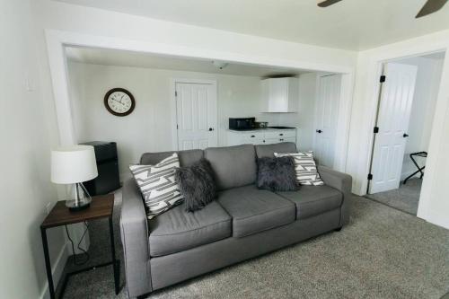 a living room with a couch and a clock on the wall at Great Location in Dayton! Updated 1 bedroom/bath. in Dayton