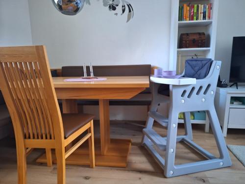 a dining room table with two chairs and a table with a stool at Hexenhäuschen in Bad Goisern
