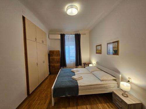 a bedroom with a bed and a large window at Charming apartment Laura Tour As Ljubljana by Town Hall in Ljubljana